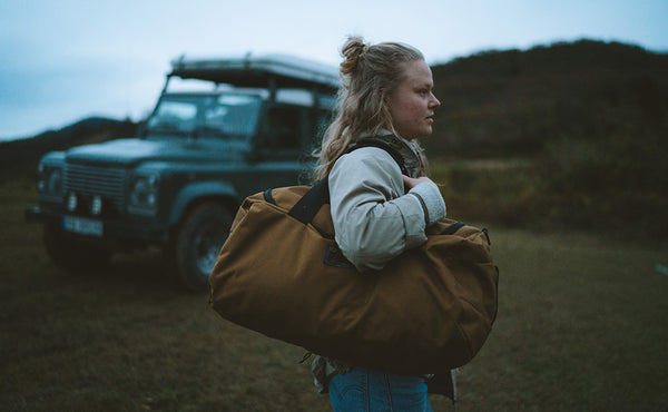 A person carrying the Yeoman Duffel on their shoulder.